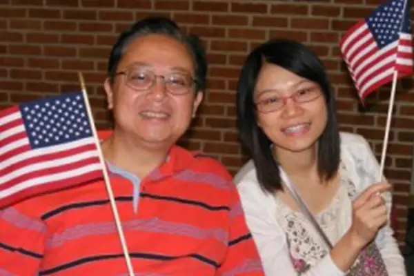 man and woman waving small american flag